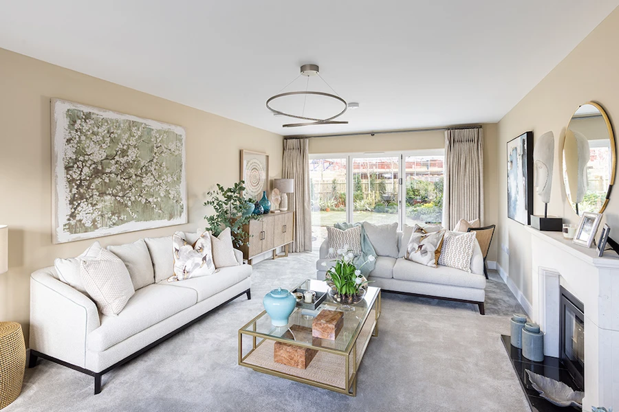 The luxe interior of a Manorwood home by Thakeham, with attractive cream sofas and gold-accented decor.